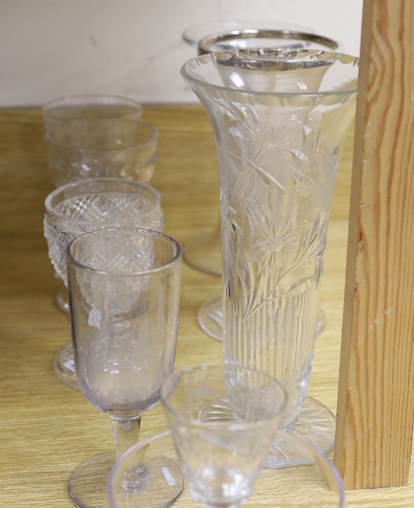 A collection of 18th and 19th century drinking glasses, etc. including rummers, engraved sherry glasses with knobbed stems, folded feet and broken pontils, a cut glass goblet, a Georgian finger bowl and stand, two vases,